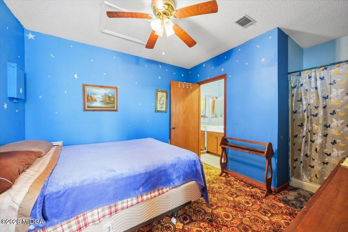 146 Mooring Road Hawkinsville, GA 31036 - Photo 46 of 64 a bedroom with a bed and a chandelier