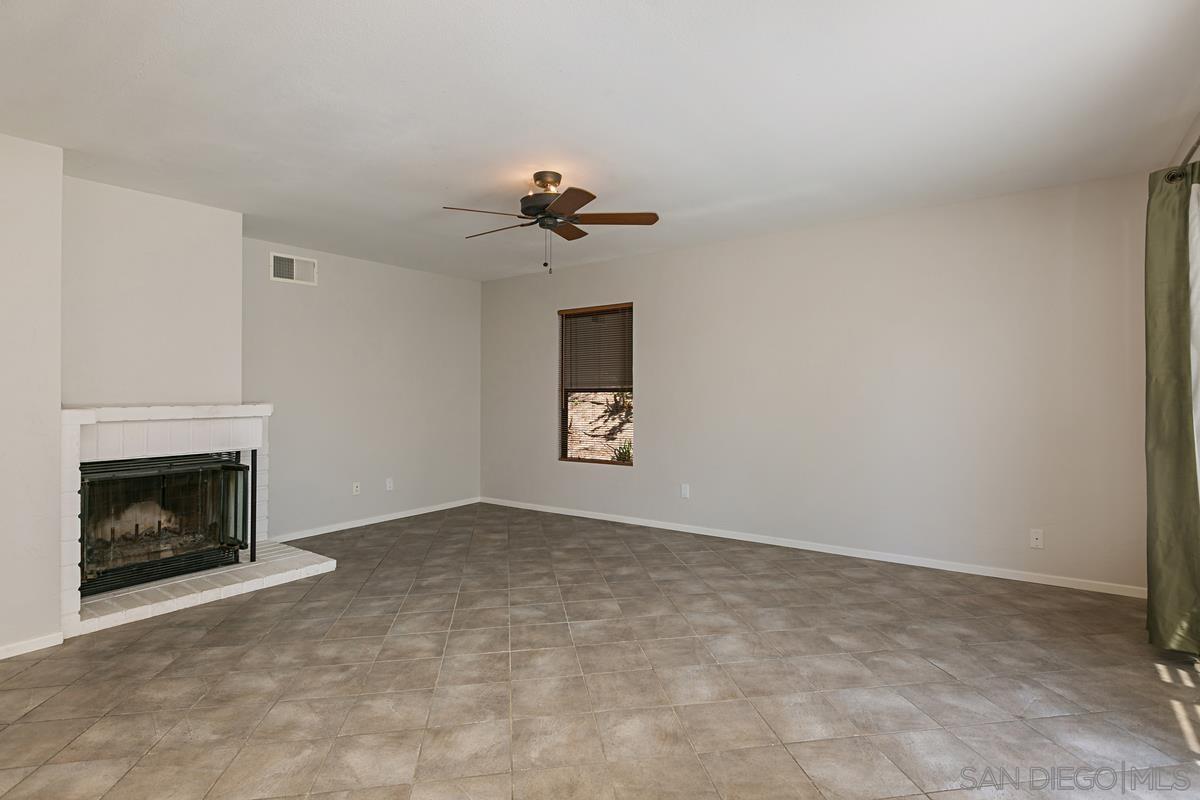 4031 Grayson Drive San Diego, CA 92130 - Photo 20 of 27 a view of an empty room with chandelier and fireplace