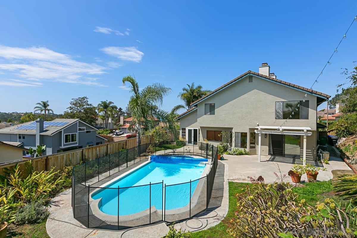 4031 Grayson Drive San Diego, CA 92130 - Photo 25 of 27 a view of a white house with a small yard and potted plants