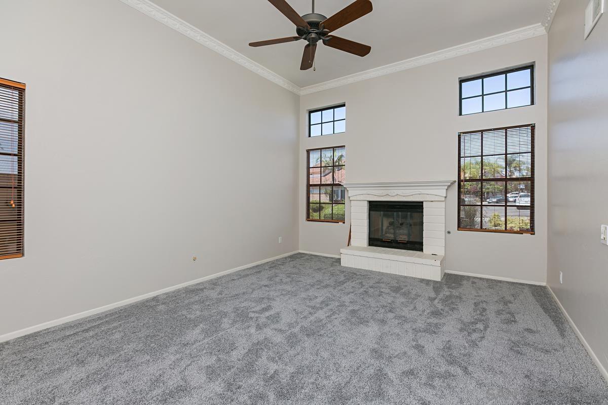 4031 Grayson Drive San Diego, CA 92130 - Photo 6 of 27 an empty room with windows and fireplace