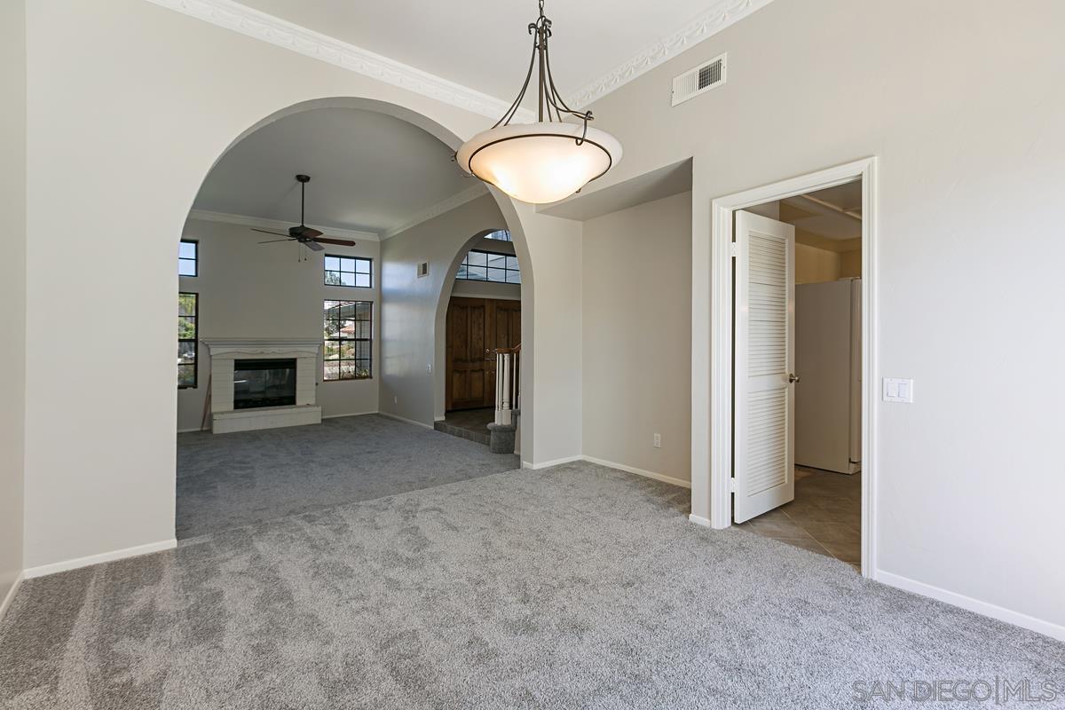 4031 Grayson Drive San Diego, CA 92130 - Photo 9 of 27 a view of a room with a fireplace and windows