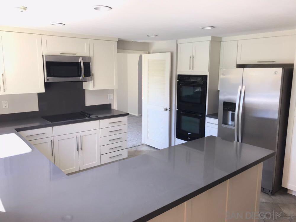 4031 Grayson Drive San Diego, CA 92130 - Photo 10 of 27 a kitchen with stainless steel appliances a refrigerator sink and microwave