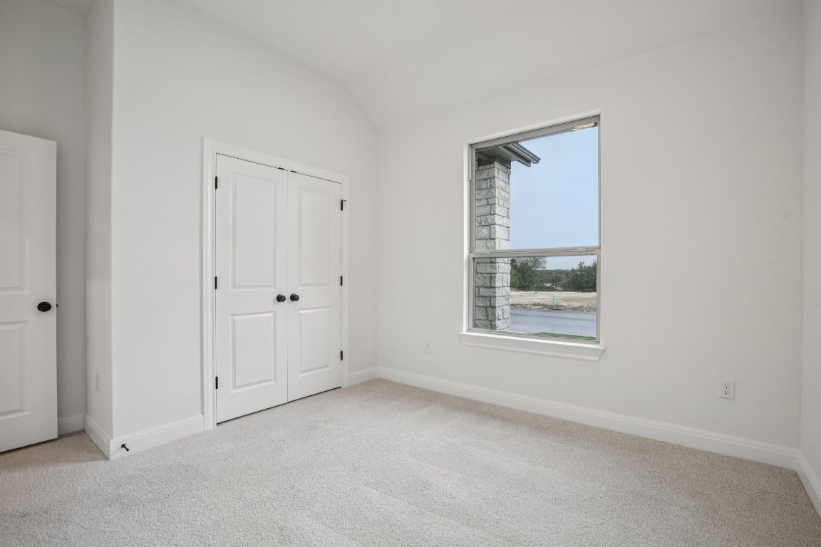 581 Treadwell Lane Kyle, TX 78640 - Photo 12 of 27 an empty room with windows and closet
