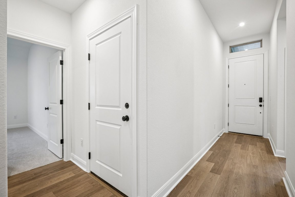 581 Treadwell Lane Kyle, TX 78640 - Photo 14 of 27 a view of hallway with wooden floor