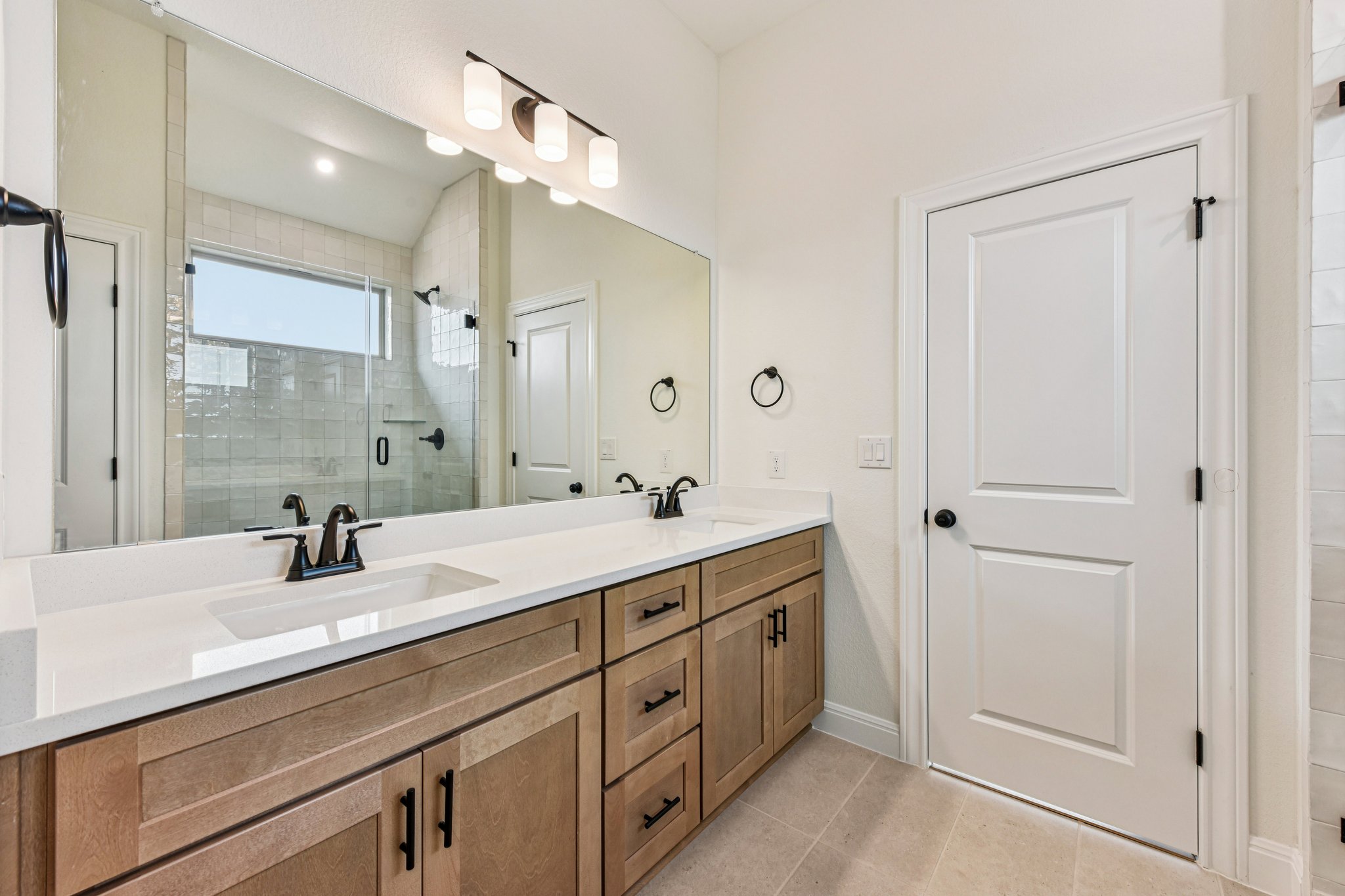 581 Treadwell Lane Kyle, TX 78640 - Photo 14 of 26 a bathroom with a double vanity sink and mirror