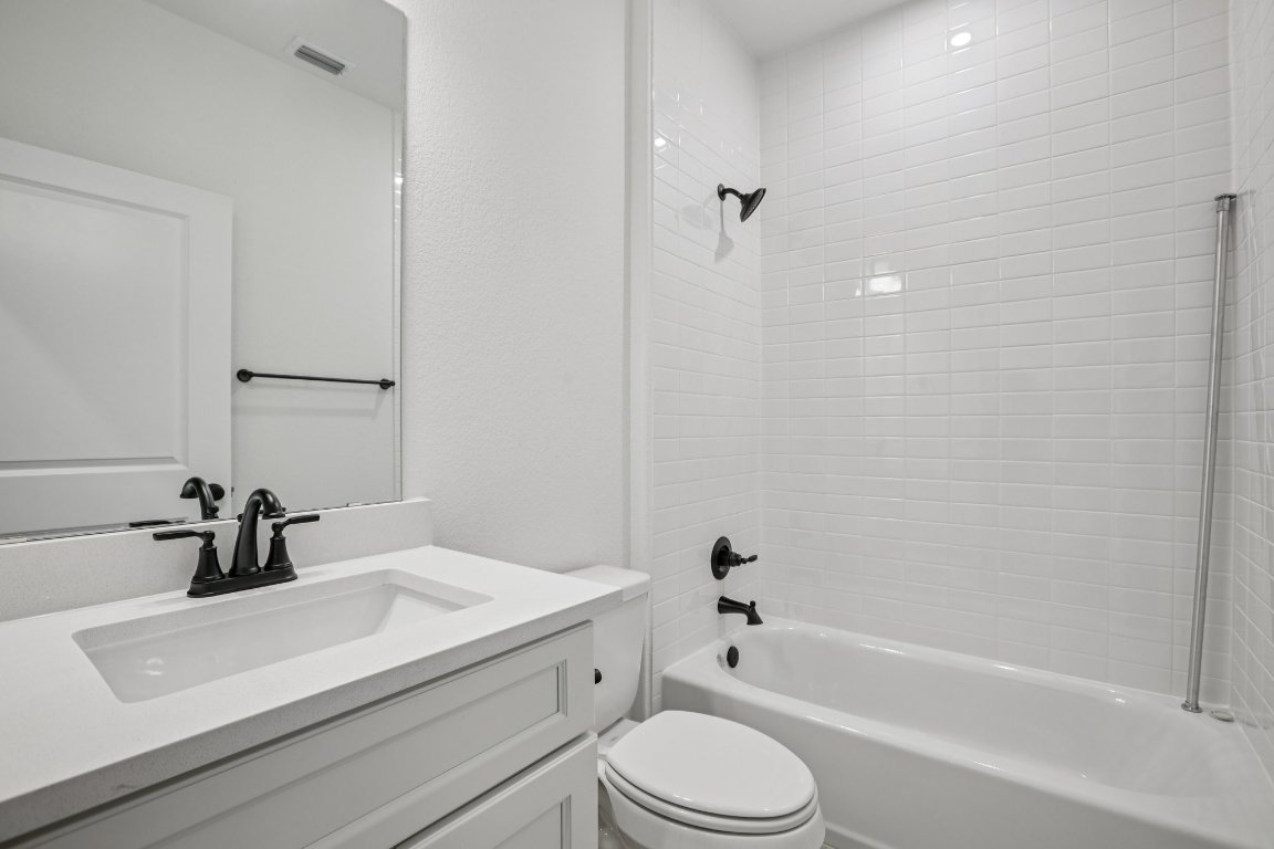 581 Treadwell Lane Kyle, TX 78640 - Photo 15 of 27 a bathroom with a sink a toilet and a bathtub
