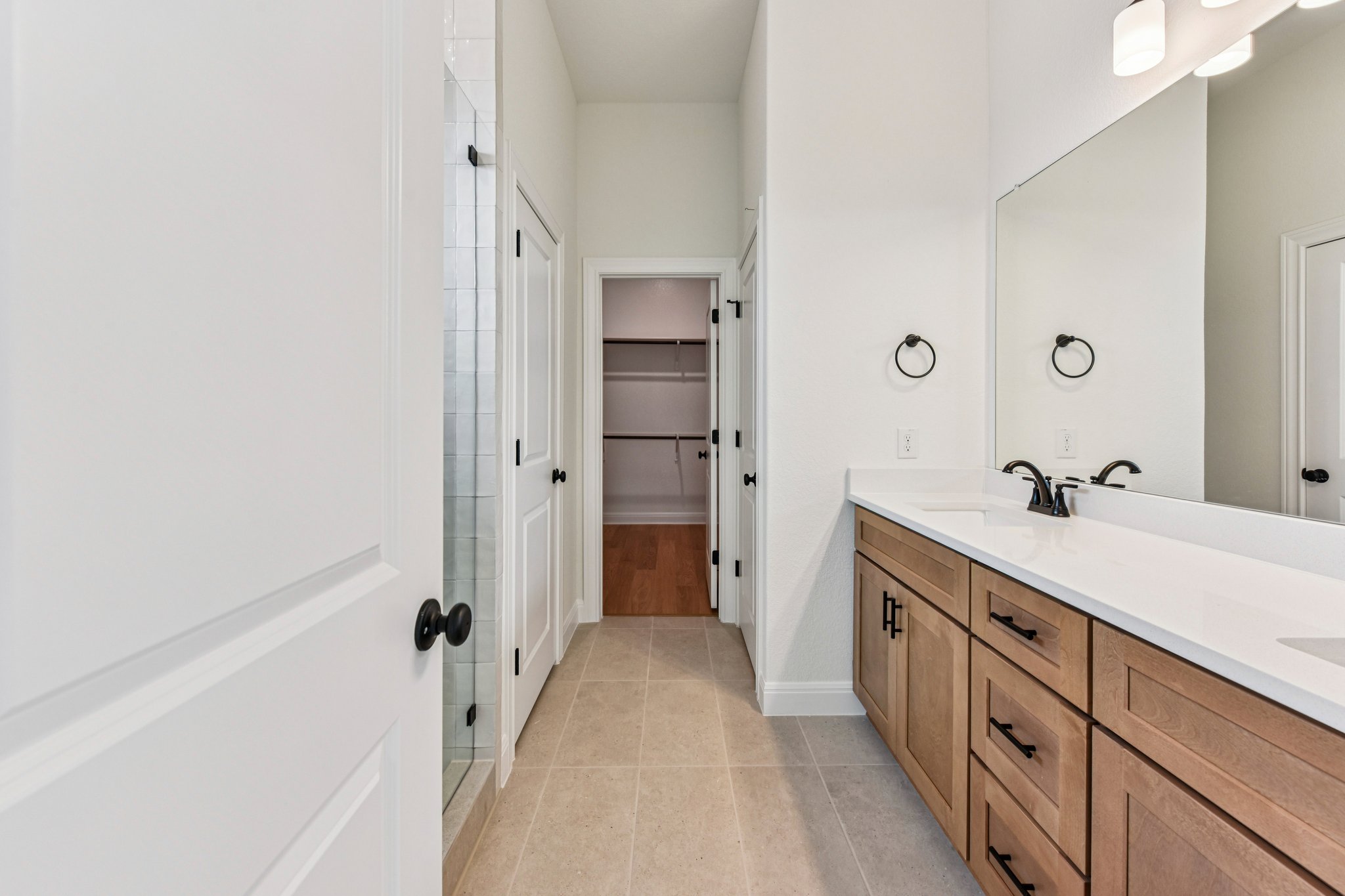 581 Treadwell Lane Kyle, TX 78640 - Photo 16 of 26 a bathroom with a double vanity sink and mirror