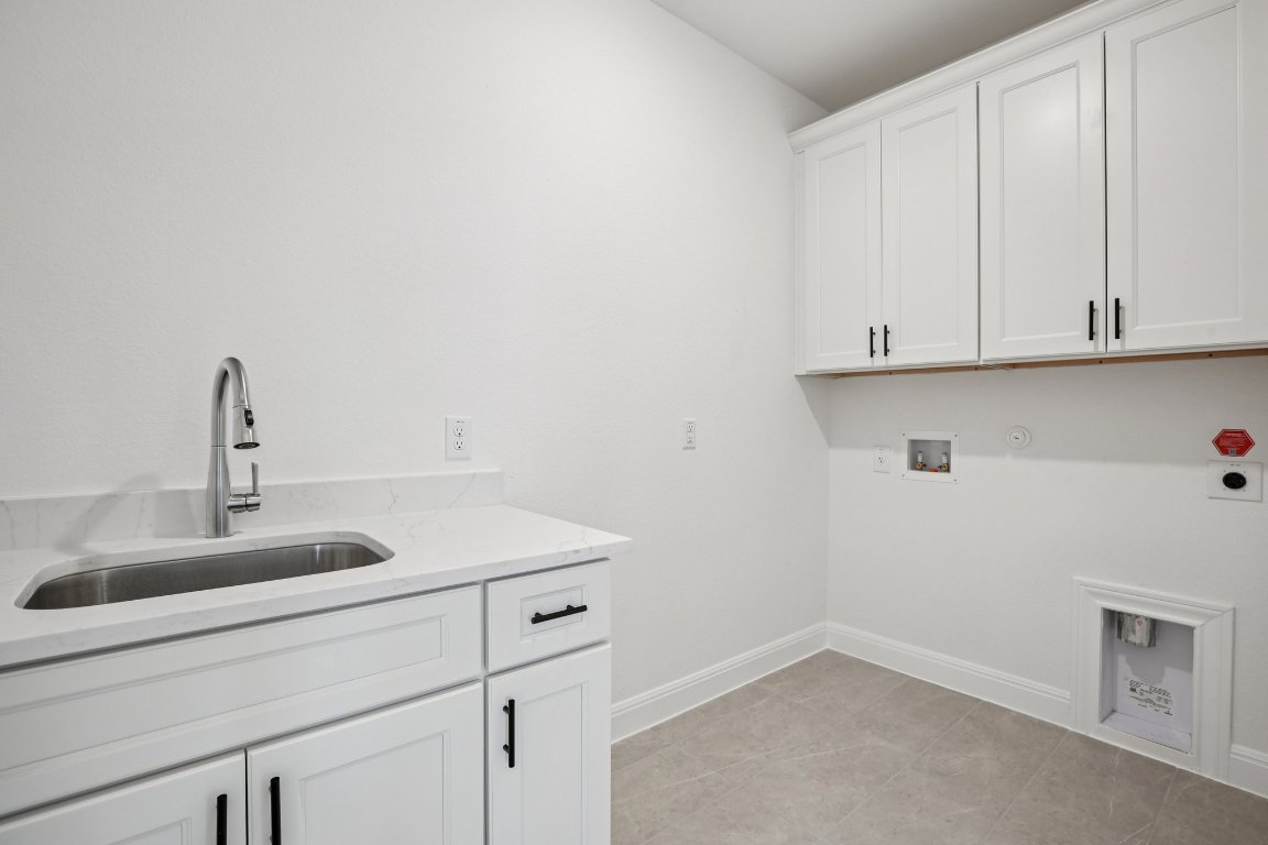 581 Treadwell Lane Kyle, TX 78640 - Photo 17 of 27 a kitchen with a sink and cabinets