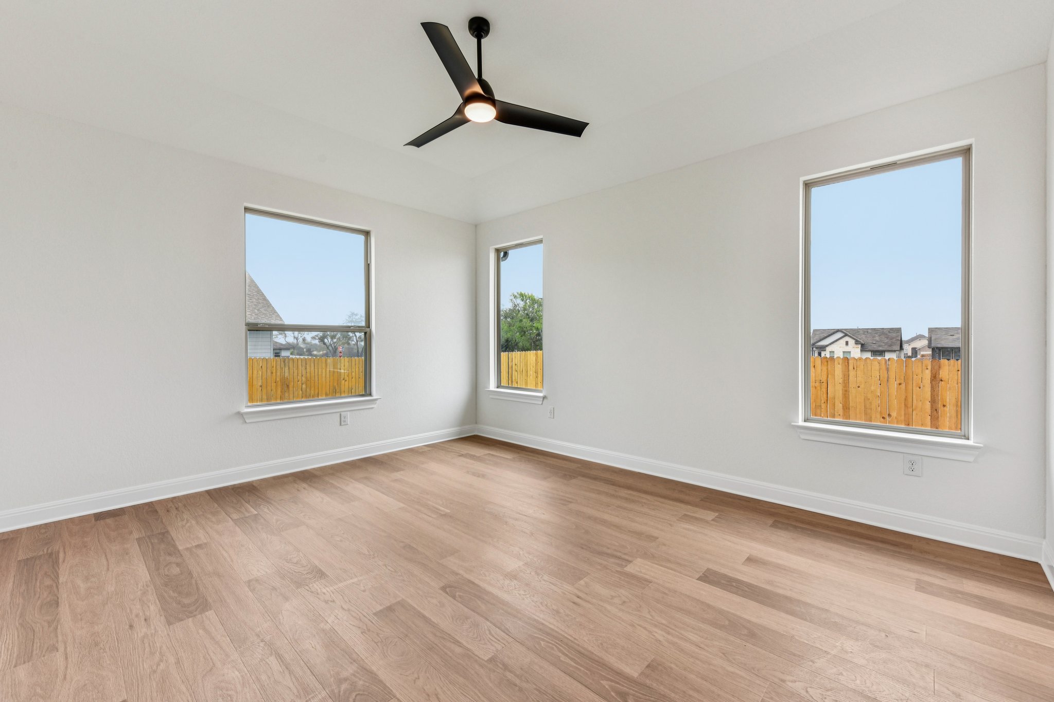 581 Treadwell Lane Kyle, TX 78640 - Photo 17 of 26 a view of an empty room with window and wooden floor