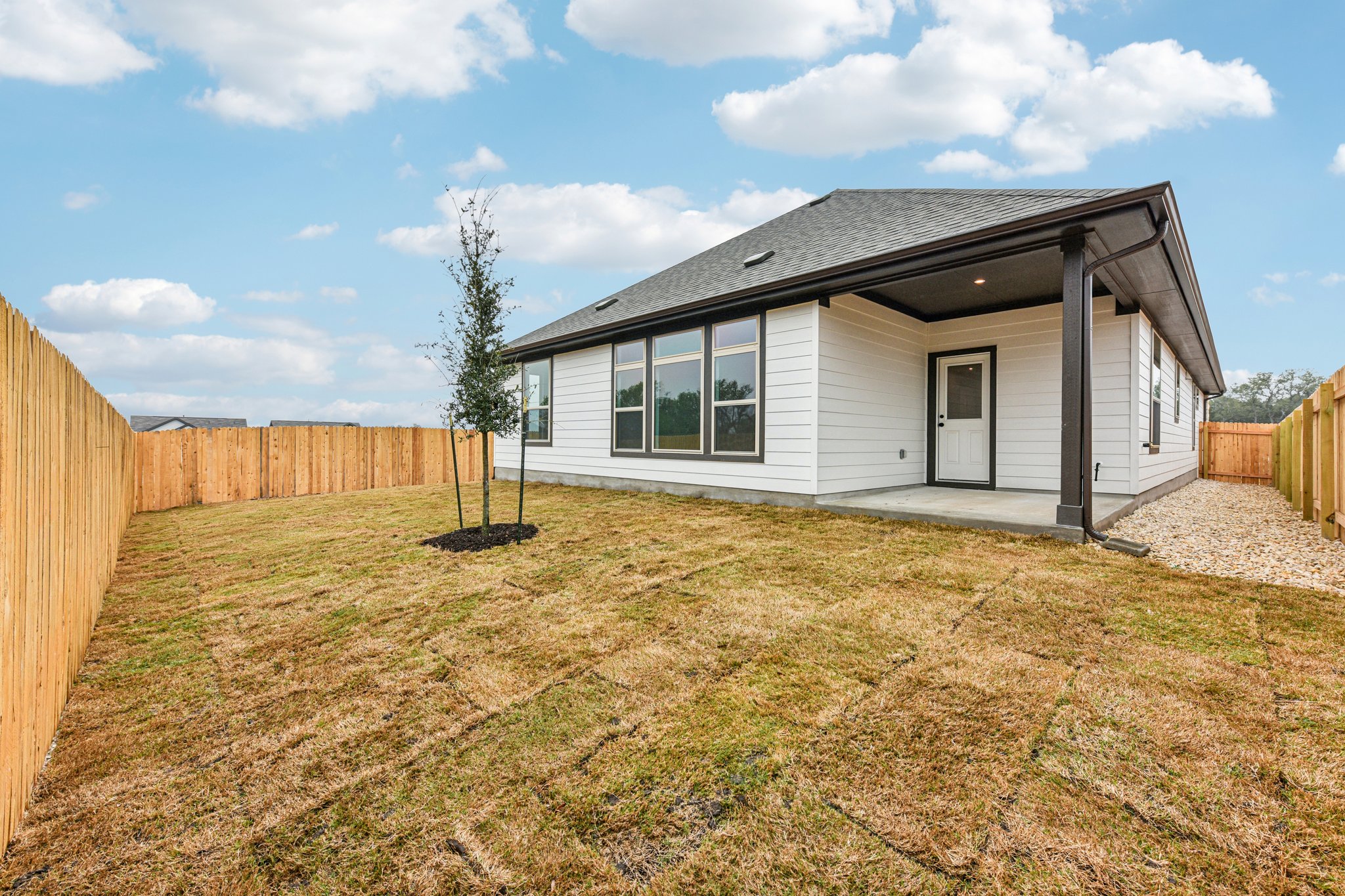 581 Treadwell Lane Kyle, TX 78640 - Photo 19 of 26 a view of a house with a wooden fence