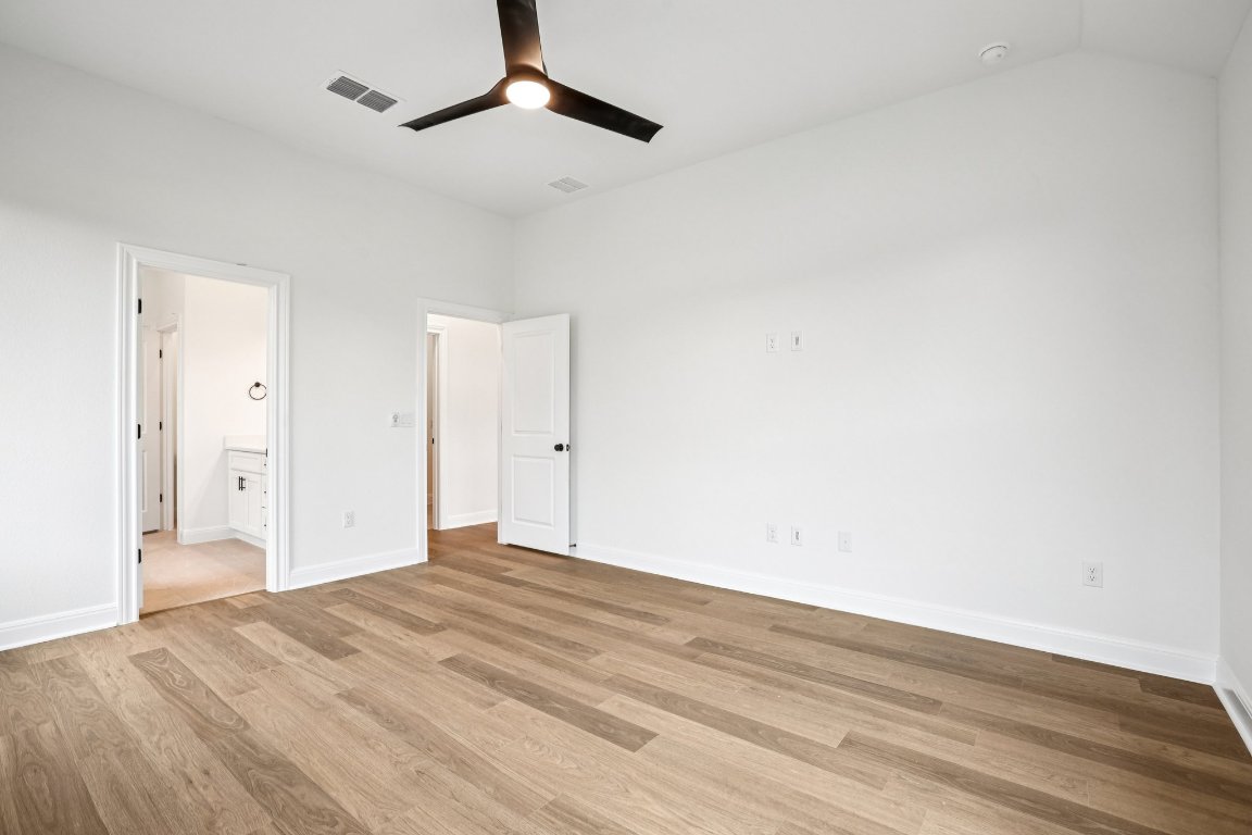 581 Treadwell Lane Kyle, TX 78640 - Photo 20 of 27 a view of empty room with wooden floor and fan