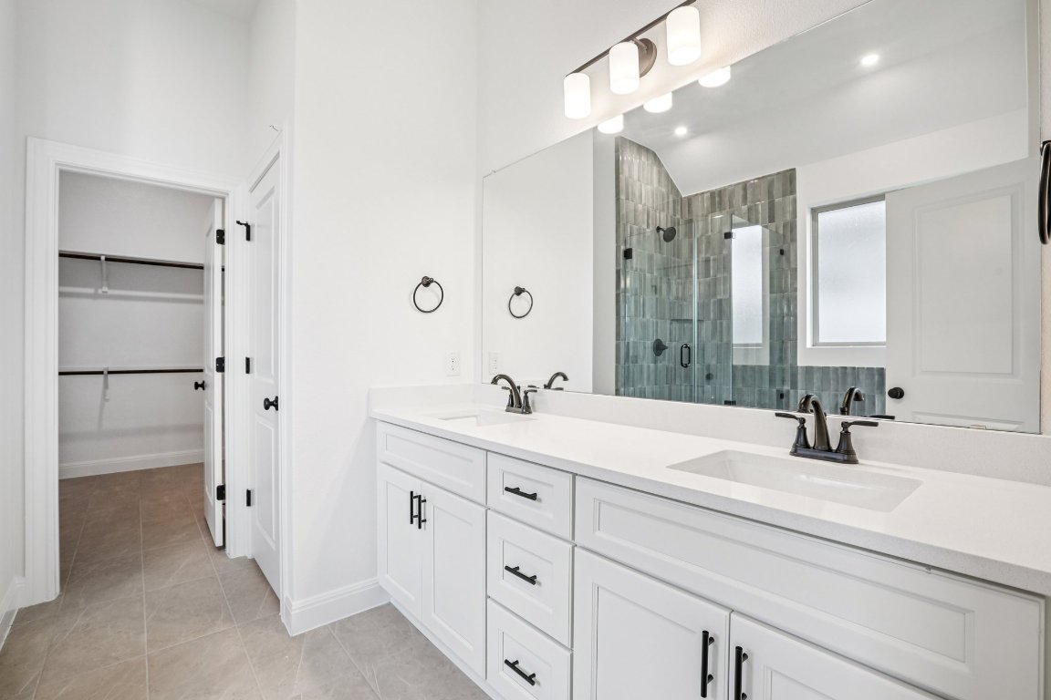 581 Treadwell Lane Kyle, TX 78640 - Photo 21 of 27 a bathroom with a double vanity sink mirror and double