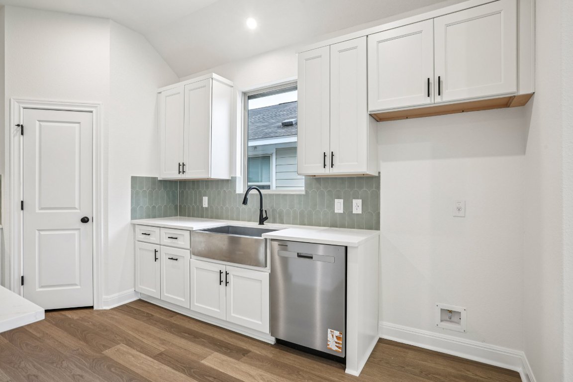 581 Treadwell Lane Kyle, TX 78640 - Photo 4 of 27 a kitchen with stainless steel appliances granite countertop a sink and cabinets with wooden floor