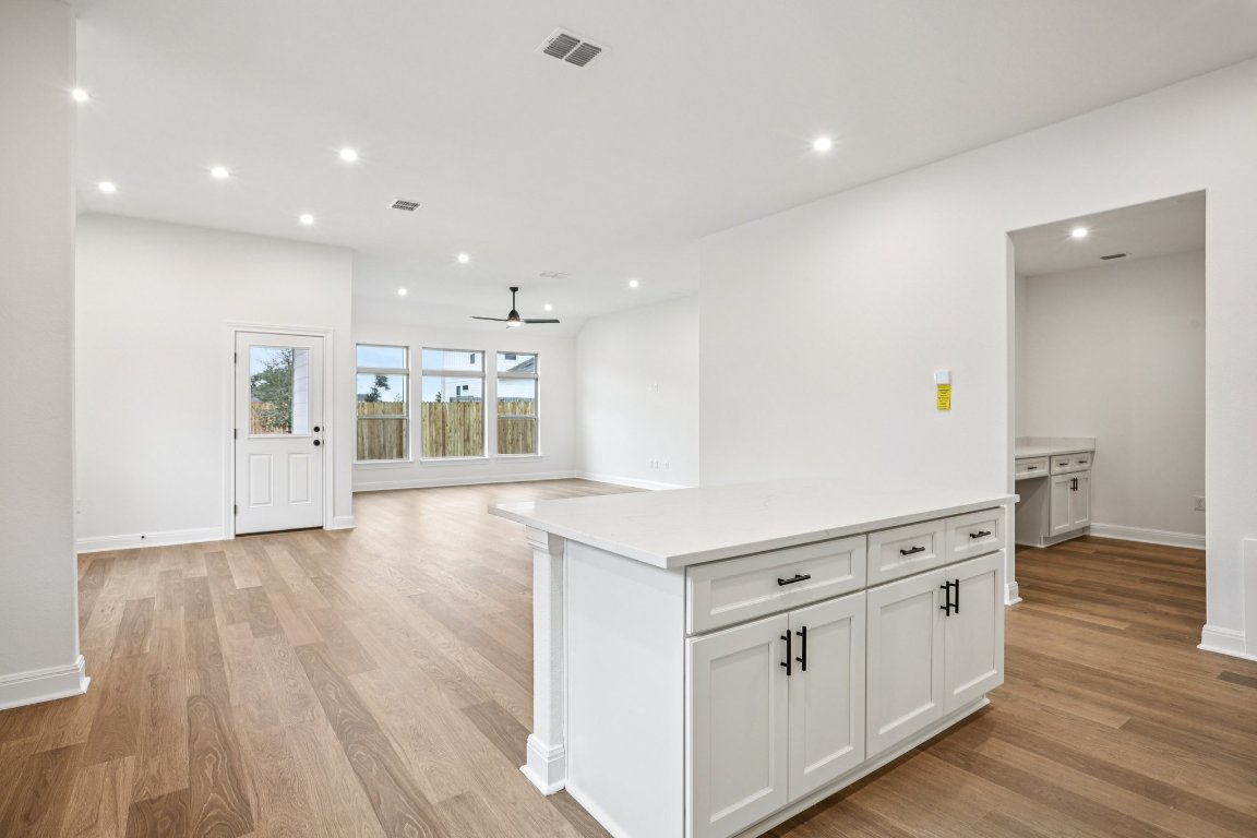 581 Treadwell Lane Kyle, TX 78640 - Photo 5 of 27 a large white kitchen with a white wooden cabinets
