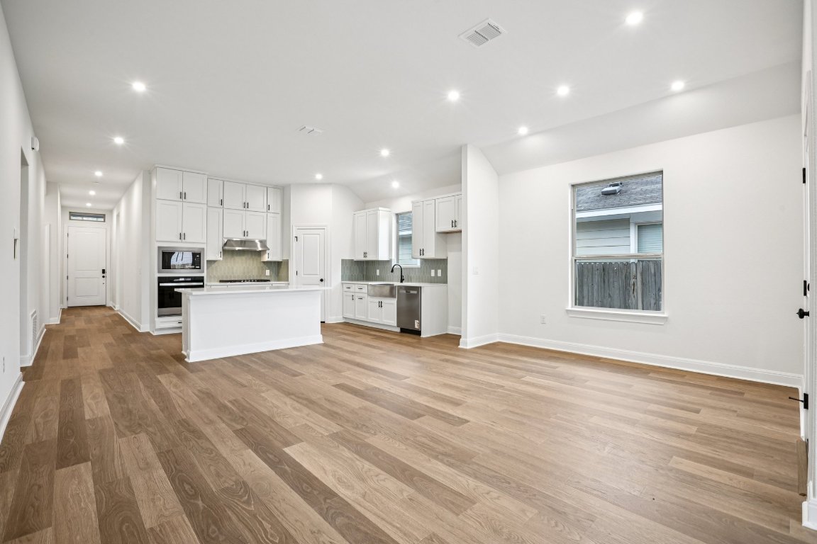 581 Treadwell Lane Kyle, TX 78640 - Photo 8 of 27 a view of kitchen with wooden floor and window