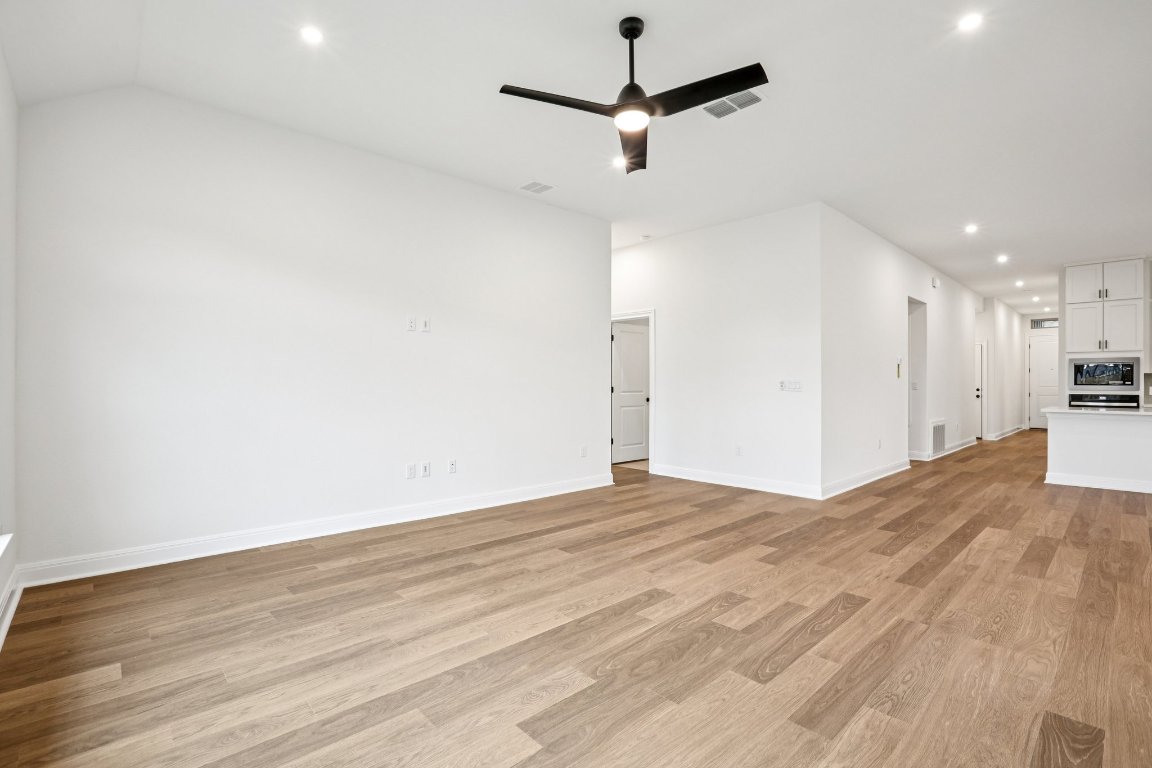 581 Treadwell Lane Kyle, TX 78640 - Photo 9 of 27 a view of empty room with wooden floor and ceiling fan
