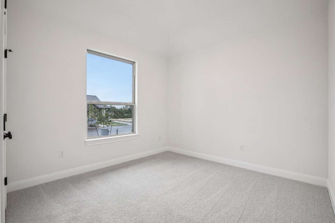 581 Treadwell Lane Kyle, TX 78640 - Photo 10 of 27 an empty room with a window