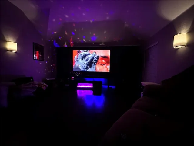 a living room with a projector screen and a projector screen