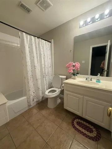 a bathroom with a sink a toilet a mirror and a bathtub