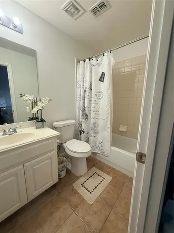 a bathroom with a toilet sink and shower