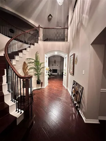 a view of entryway and hall with wooden floor