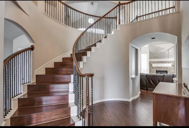 a view of entryway and hall with wooden floor