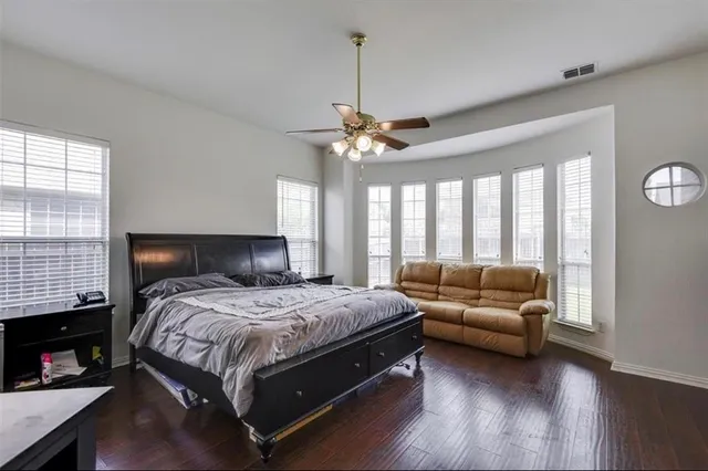 a bedroom with a bed couch and a window