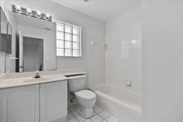 an empty room with a window and ceiling fan