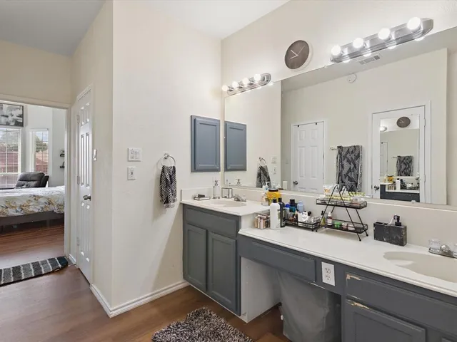 a bathroom with a sink double vanity granite tub and shower