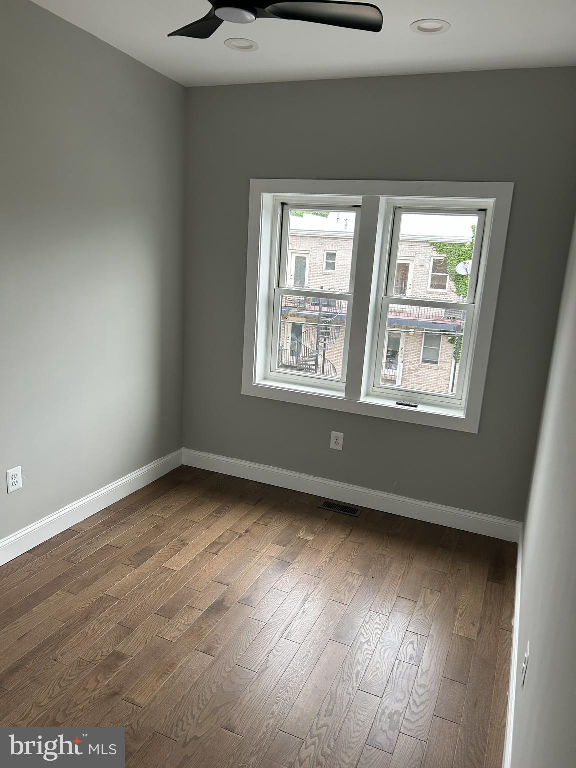 928 Perry Place Northeast Washington, DC 20017 - Photo 10 of 16 a view of an empty room with wooden floor and a window