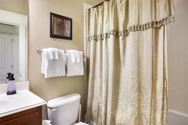a white toilet sitting next to a bathroom sink