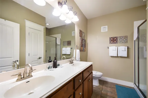 a bathroom with a sink a toilet and a mirror