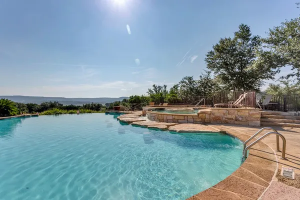 a view of swimming pool with outdoor seating and lake