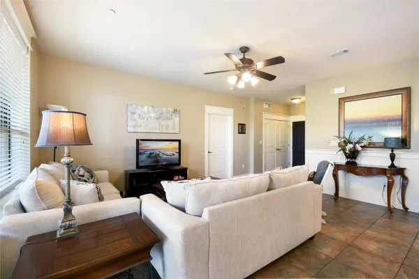 a living room with furniture fireplace and a large window