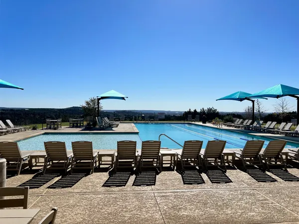 a view of a lake with couches chairs