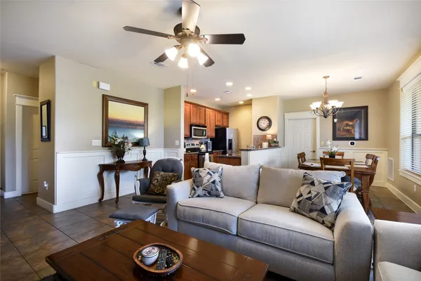 a living room with furniture and a chandelier
