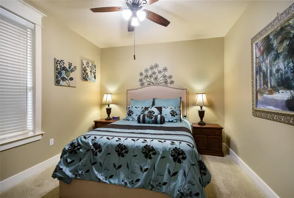 a bedroom with a bed and lamp on the dresser