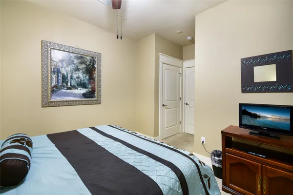 a bedroom with a bed and a flat screen tv