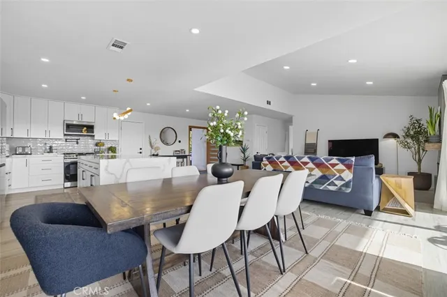 a dining room with furniture and wooden floor