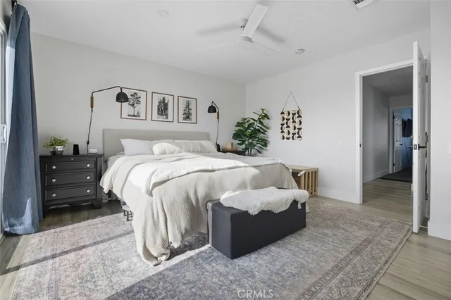 a bedroom with a bed and a painting on the wall