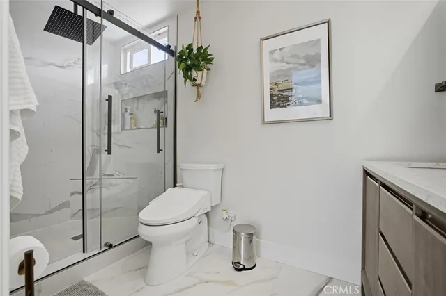 a bathroom with a toilet and a shower