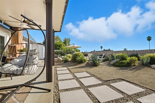 a view of a house with backyard and sitting area