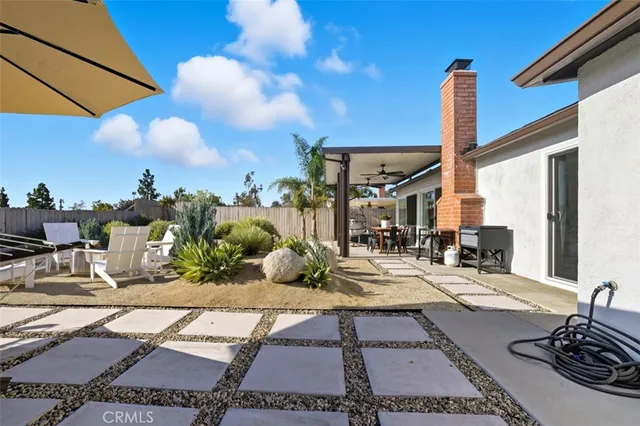 a view of a patio with a table and chairs