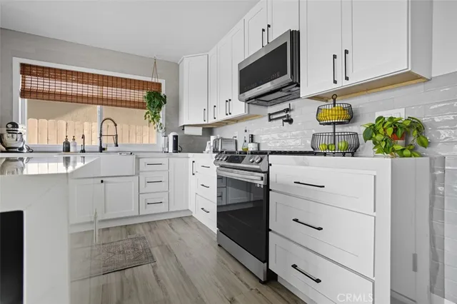 a kitchen with a sink window and cabinets