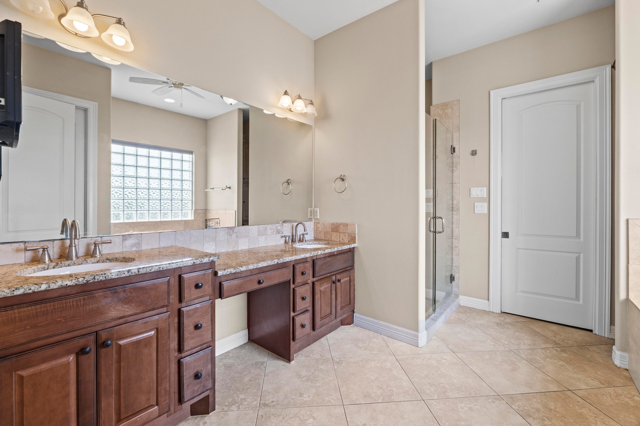 8293 Lime Creek Road Leander, TX 78641 - Photo 29 of 38 a spacious bathroom with a granite countertop sink a mirror and a