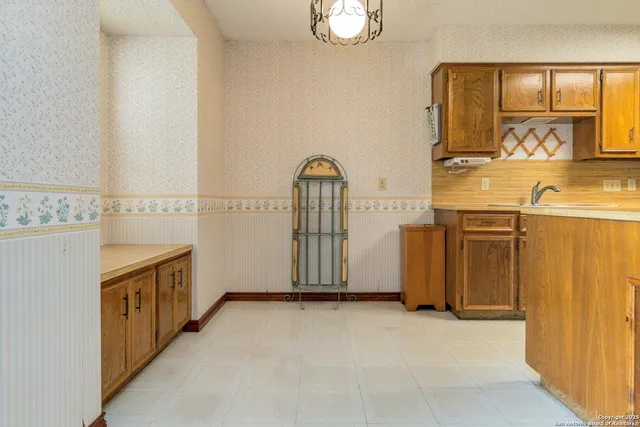 a view of a kitchen with an entryway and a wooden floor