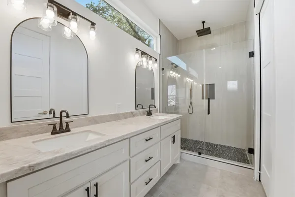 a bathroom with a double vanity sink mirror and double
