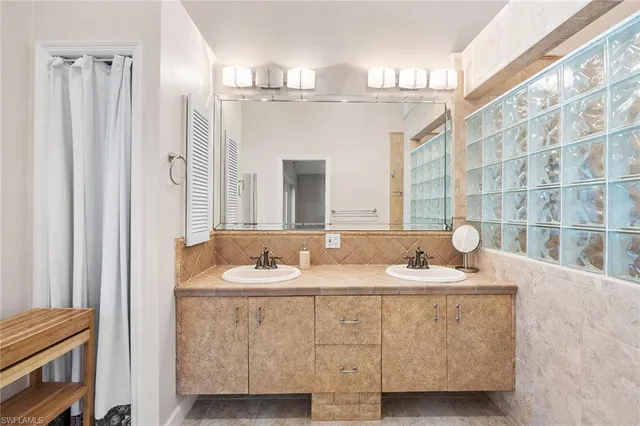 a bathroom with a double vanity sink and a mirror
