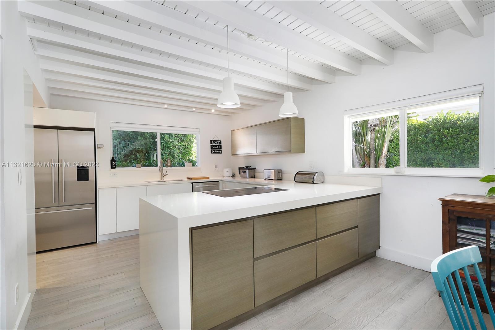 425 Glenridge Road Key Biscayne, FL 33149 - Photo 12 of 37 a kitchen with stainless steel appliances granite countertop a sink and a large window