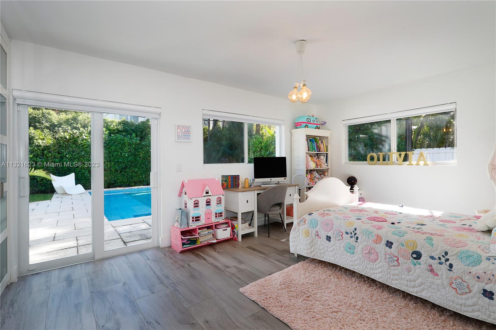 425 Glenridge Road Key Biscayne, FL 33149 - Photo 19 of 37 a bedroom with bed and glass door